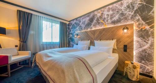 a hotel room with a large bed and a window at PLAZA INN Salzburg Messe in Salzburg