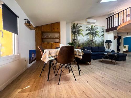 a living room with a table and a blue couch at The globe trotter - Perpignan in Perpignan