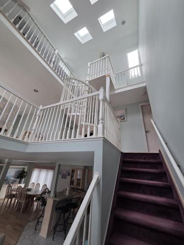 a staircase in a house with a table and chairs at Seascape in Haven Beach