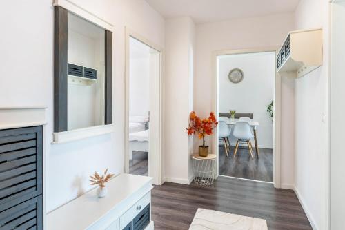 a living room with white walls and a large mirror at Haus Gera in Gera