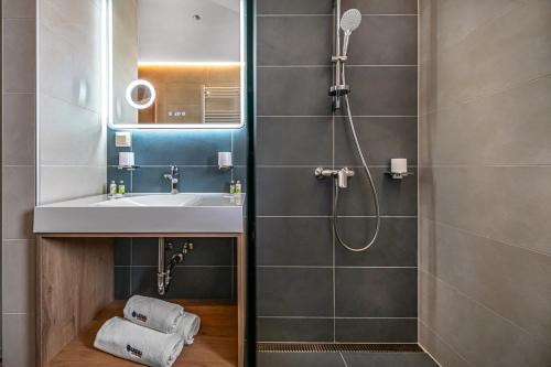 a bathroom with a sink and a shower at Lazuli Apartment in Hegykő