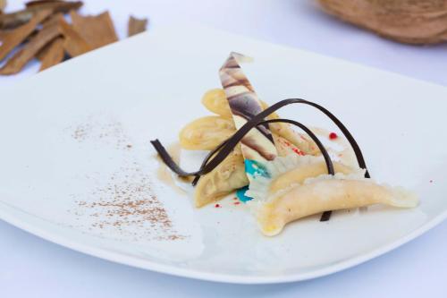 a plate of food on a white plate at The Grandmark Dhaka in Dhaka