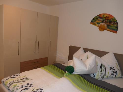 a bedroom with a bed with white sheets and pillows at Chads City Apartment mit Tiefgarage free parking in Graz