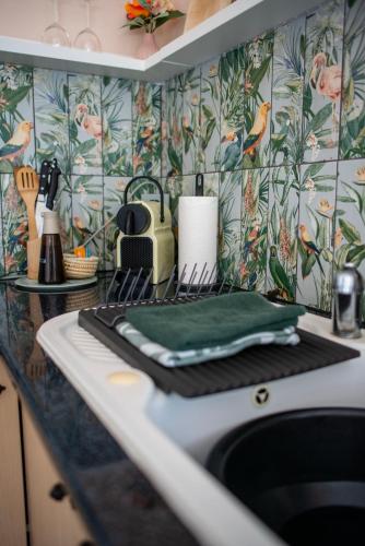 a kitchen counter with a sink with a green towel at Casa Carla Andalucia, el Torcal in Almogía