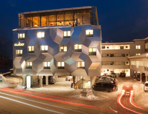 a building with a geometric design on the side of it at Cubo Sport & Art Hotel in Sankt Johann in Tirol