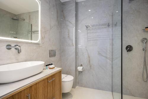 a bathroom with a toilet and a sink and a shower at Antonias Serenity in Loutra