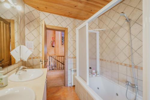 a bathroom with a tub and a sink and a shower at Peña in Castro de Fuentidueña