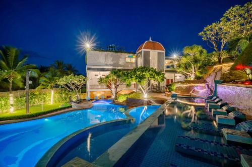 a resort with a swimming pool at night at Green Oasis Nha Trang Resort in Nha Trang