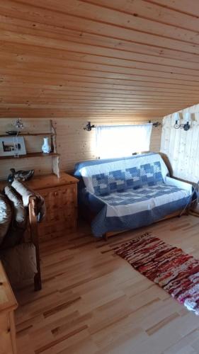 a bedroom with a bed in a wooden cabin at Chalet Glauninger in Ramsau am Dachstein