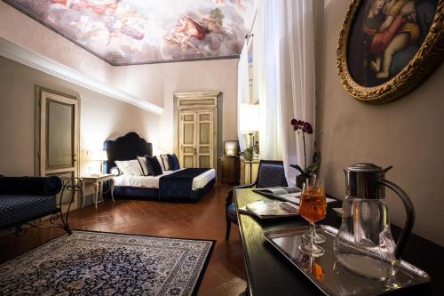 a living room with a painting on the ceiling at Hotel Burchianti in Florence