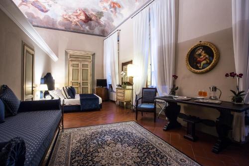 a living room with a painting on the ceiling at Hotel Burchianti in Florence