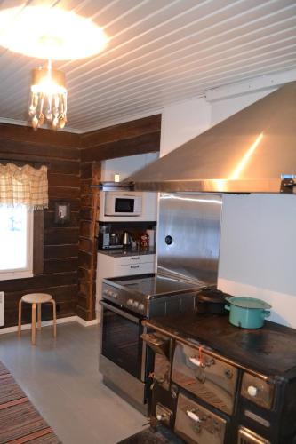 a kitchen with a stove and a stove top oven at Guesthouse Torppa in Korkeakoski