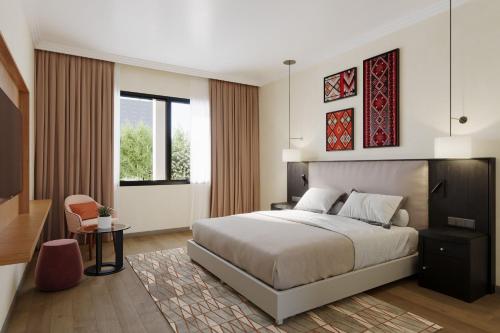 a bedroom with a large bed and a chair at Casablanca Marriott Hotel in Casablanca