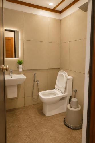 a bathroom with a toilet and a sink at Nova North Inn in Cochin