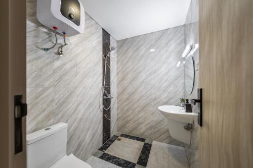 a small bathroom with a toilet and a sink at Cove Juanda One in Jakarta