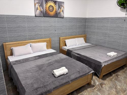 two beds in a room with two bedsitures at Khách sạn Hotel 6 in Ấp Tân Thành