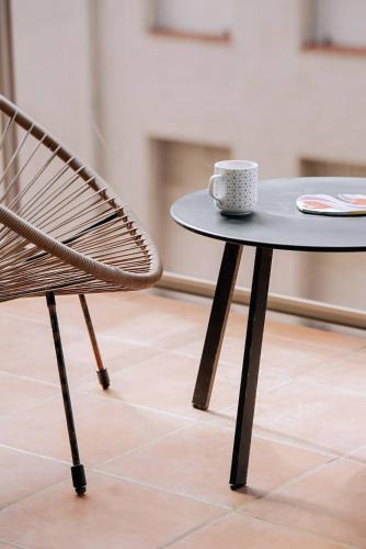 a table and a chair with a coffee cup on it at La bulle canetoise - vue mer in Canet-en-Roussillon
