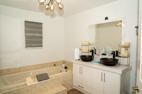 a bathroom with a tub and a sink and a mirror at Mountain Retreat Hope in Hope