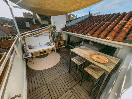 a balcony with a chair and a table on a roof at O Saudade - Centre Perpignan in Perpignan