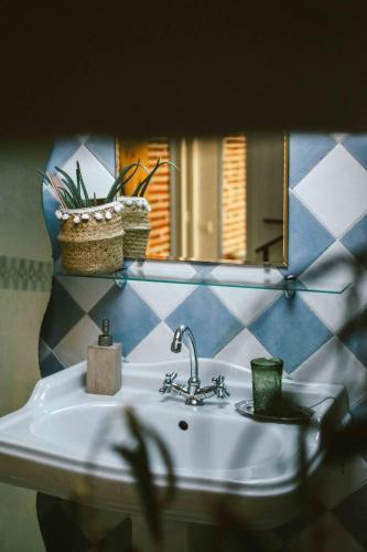a bathroom with a sink and a mirror at O Saudade - Centre Perpignan in Perpignan