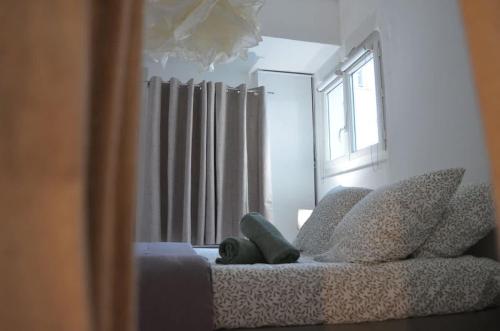 a living room with a couch and a window at El Niu - Perpignan hyper centre in Perpignan