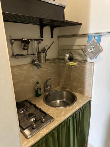 a kitchen counter with a sink and a stove at Anfiteatro apartment in Formia