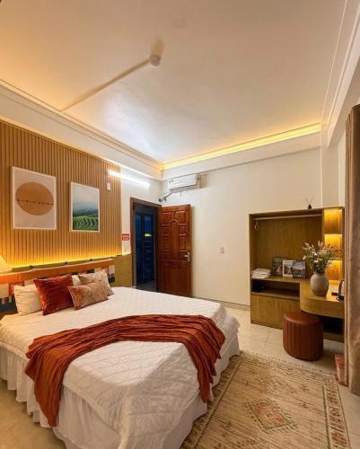 a bedroom with a large bed and a desk at The Ha Giang Loop Hostel in Ha Giang