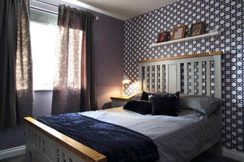 a bedroom with a large bed and a window at Apartment Pilrig Heights in Edinburgh