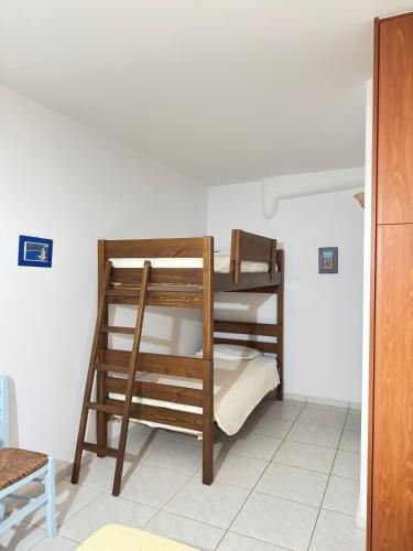 a room with two bunk beds in a room at Calm Paros in Logaras
