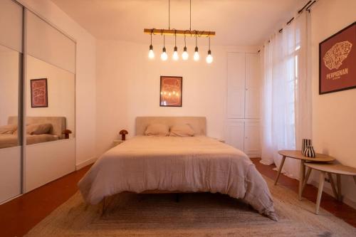 a bedroom with a bed and a large window at Le Cocon d'Or Perpignan Centre in Perpignan