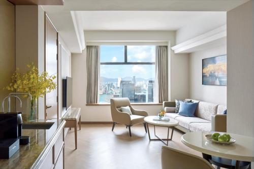 a living room with a couch and a table at Hopewell Hotel in Hong Kong