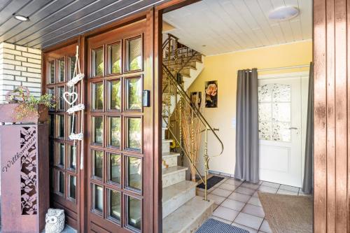 a home entrance with a wooden door and stairs at Storchenallee in Burg