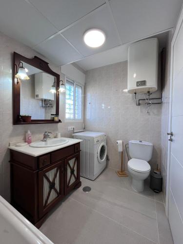 a bathroom with a sink and a toilet and a mirror at Eco Espacio Camaleón Verde 2 in Cartagena