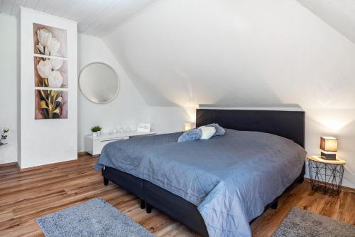 a bedroom with a large bed in a white room at Storchenallee in Burg