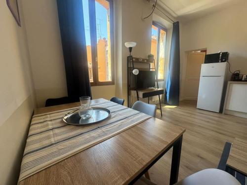 a wooden table with a plate on top of it at Le Nomad - Perpignan center in Perpignan