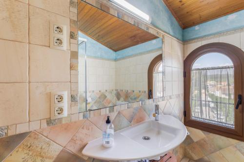 a bathroom with a sink and a mirror at Els Castellers in Sant Pau dʼOrdal
