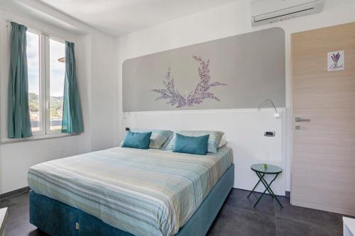 a bedroom with a large bed with blue pillows at Domi Home in La Spezia