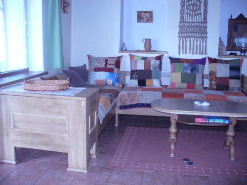 a living room with a couch and a table at Chalupa na lazoch in Nová Baňa