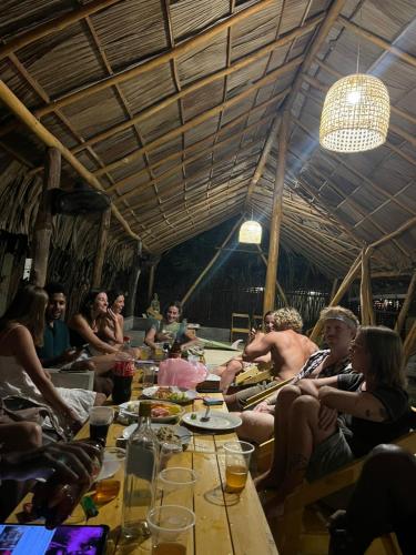 a group of people sitting around a table at Funky Monkey Surfhostel Hiriketiya in Hiriketiya