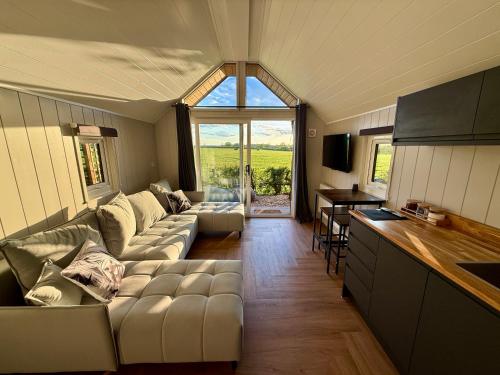 a living room with a couch and a table at Rhosyn Highland Cattle Farm in Dunstall