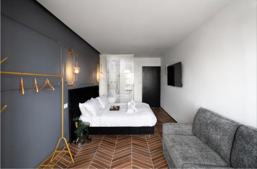 a living room with a bed and a couch at City tower 16 floor in Jerusalem
