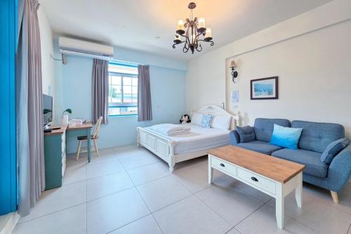 a living room with a couch and a table at Village Villa B&B in Zhuqi