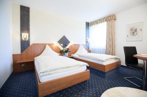 Ένα ή περισσότερα κρεβάτια σε δωμάτιο στο Hotel Alt Riemsloh