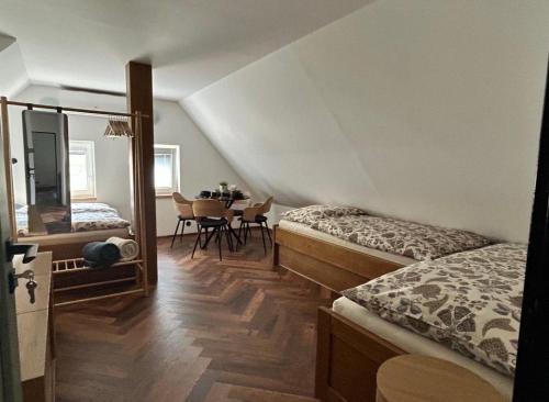 a bedroom with two beds and a table in it at Na Špici Bítov in Bítov