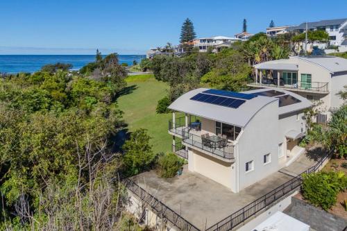 an aerial view of a house with solar panels on the roof at Surfside in East Ballina