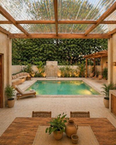 a swimming pool in a patio with a pergola at Alba Villa in Gili Trawangan