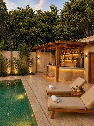 a backyard with a swimming pool and a bar at Alba Villa in Gili Trawangan