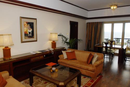 a living room with a couch and a table at Taj Samudra, Colombo in Colombo