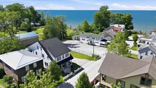 an aerial view of a town with houses and the ocean at Dragonfly Guest House-GOTL Strip in Geneva