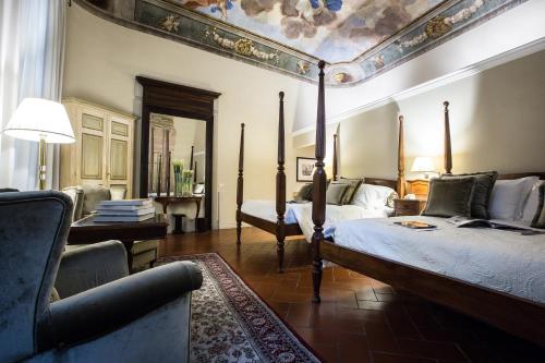 a bedroom with two beds and a couch in it at Hotel Burchianti in Florence